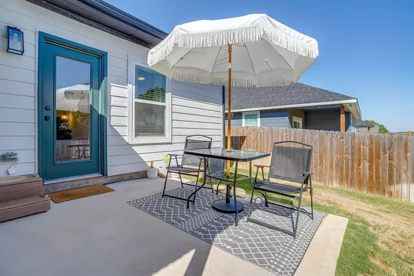 a view of a patio with a table and chairs