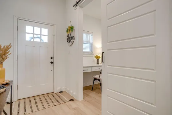 a view of an entryway with wooden floor