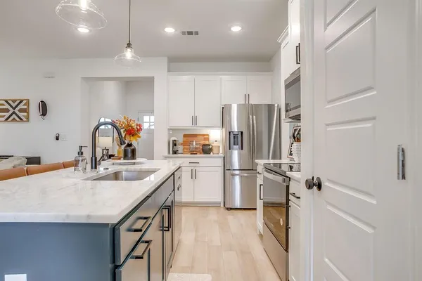 a kitchen with refrigerator and cabinets