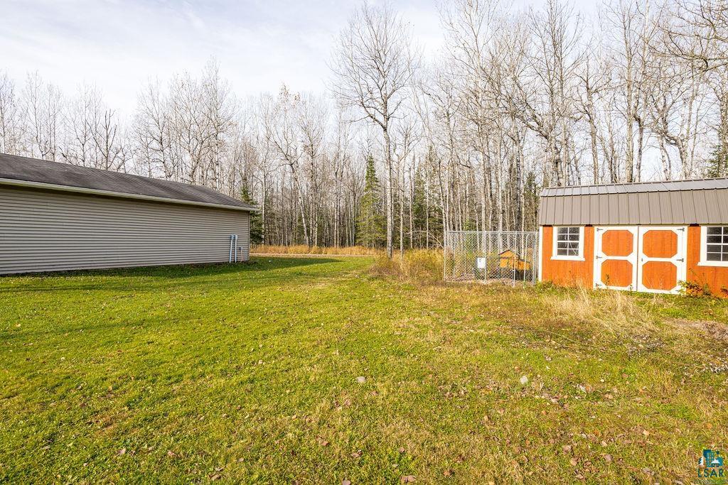 6048 Lakewood Road Duluth, MN 55804 - Photo 18 of 65 View of grassy yard with a storage unit