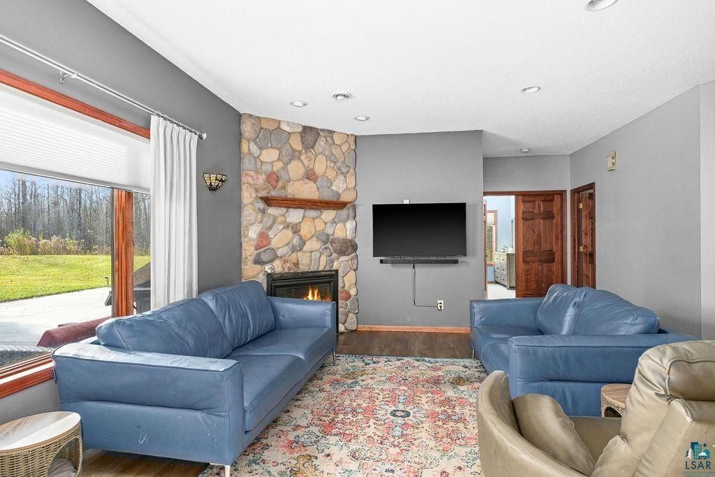 6048 Lakewood Road Duluth, MN 55804 - Photo 28 of 65 Living room featuring a stone fireplace, wood finished floors, and recessed lighting