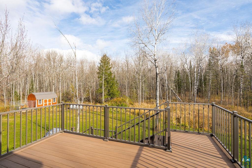 6048 Lakewood Road Duluth, MN 55804 - Photo 37 of 65 Wooden deck featuring a lawn, a forest view, and a shed