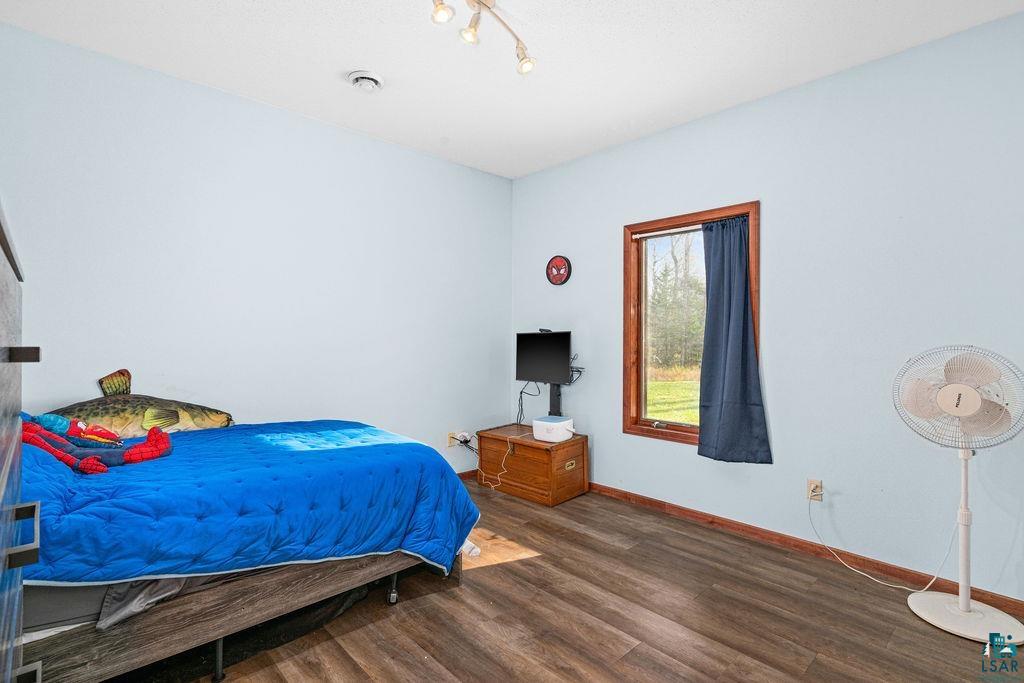 6048 Lakewood Road Duluth, MN 55804 - Photo 52 of 65 Bedroom with dark wood-style flooring and baseboards