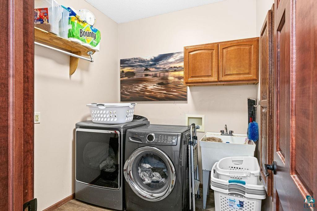 6048 Lakewood Road Duluth, MN 55804 - Photo 53 of 65 Laundry room featuring cabinet space and washing machine and dryer