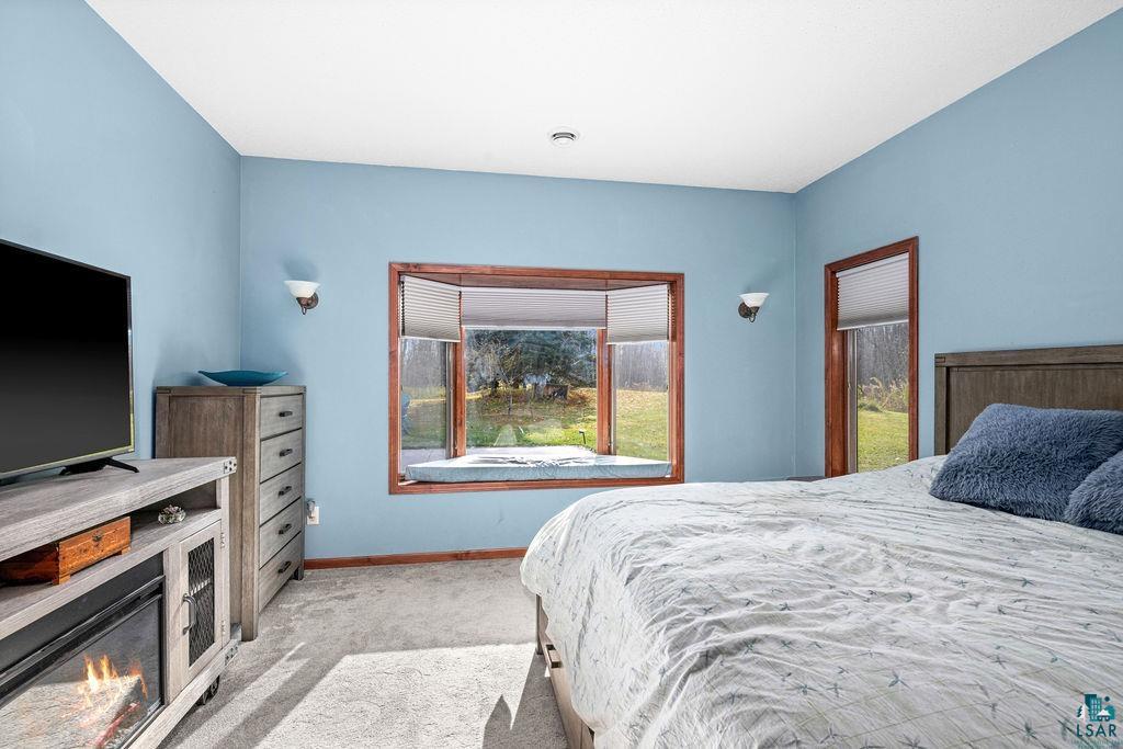6048 Lakewood Road Duluth, MN 55804 - Photo 61 of 65 Bedroom featuring light carpet and baseboards