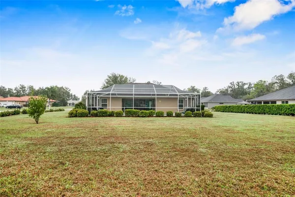 a front view of a house with a big yard