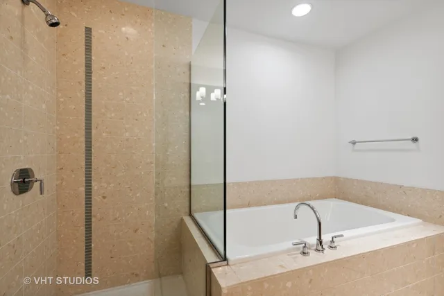 a bathroom with a bathtub and a shower