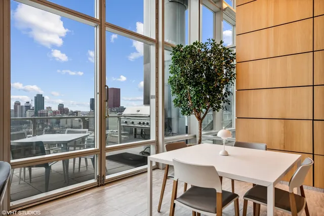 a view of a balcony dining table and chairs with wooden floor