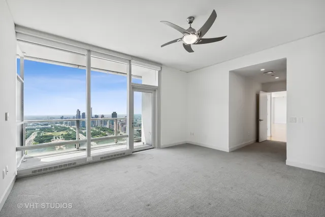 a view of a livingroom with a ceiling fan and window