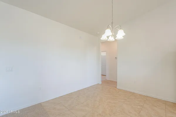 a view of a kitchen with furniture and stainless steel appliances