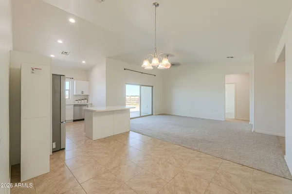 a kitchen with cabinets appliances a sink and a window