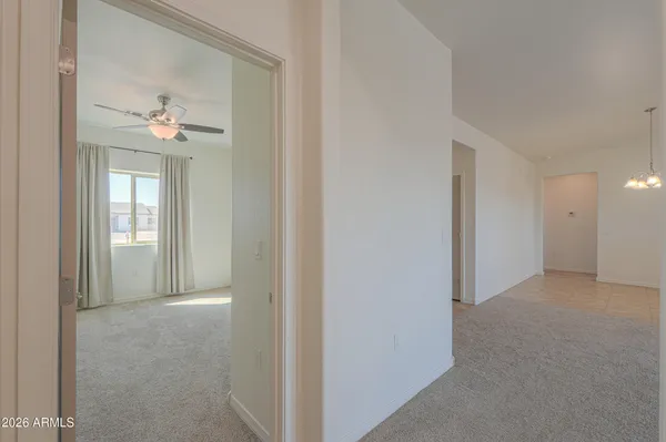 an empty room with fan and windows