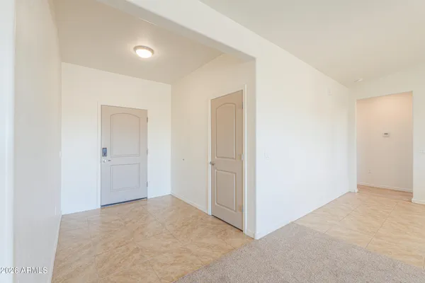 an empty room with a ceiling fan and a window