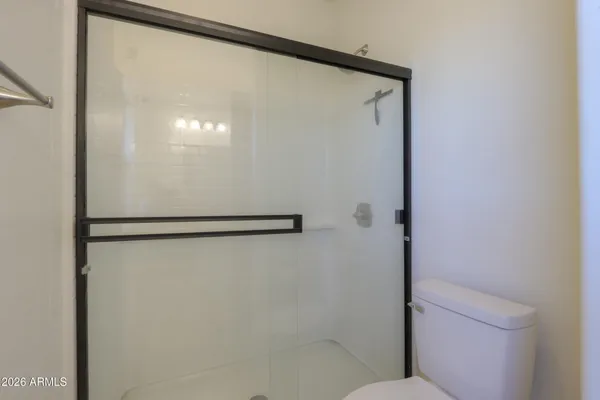 a view of a livingroom with lounge chair and a ceiling fan
