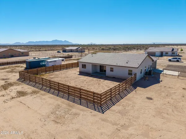 a backyard of a house with wooden fence