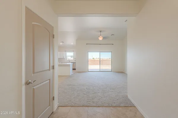 a view of a kitchen with a refrigerator and a stove top oven