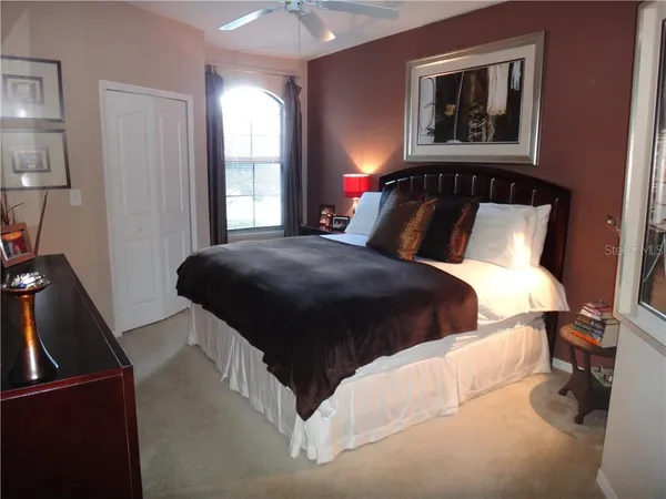 a bedroom with a bed and a mirror