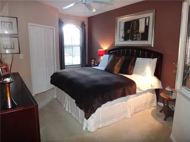 a bedroom with a bed and a mirror