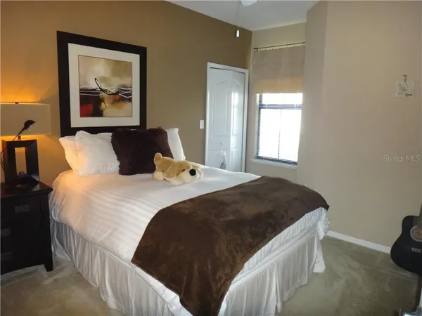 a bedroom with a bed and window