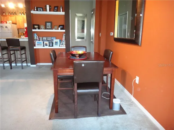 a view of a dining room with furniture and a rug