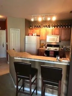 a kitchen with a stove a sink a refrigerator and a refrigerator