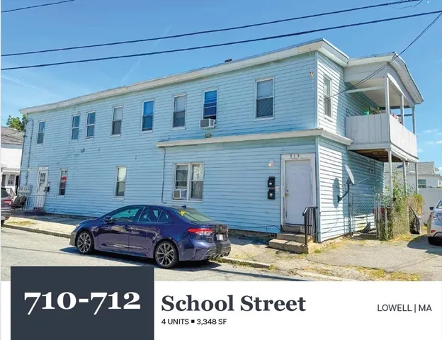 a front view of a house with a parking space