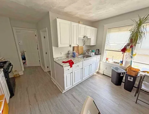 a storage room with wooden floor washer and dryer