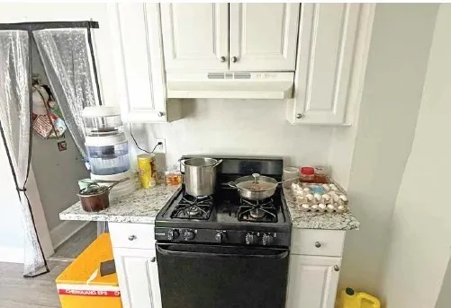 a kitchen with a stove and a white cabinet
