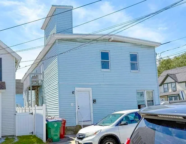 a front view of a house with parking space