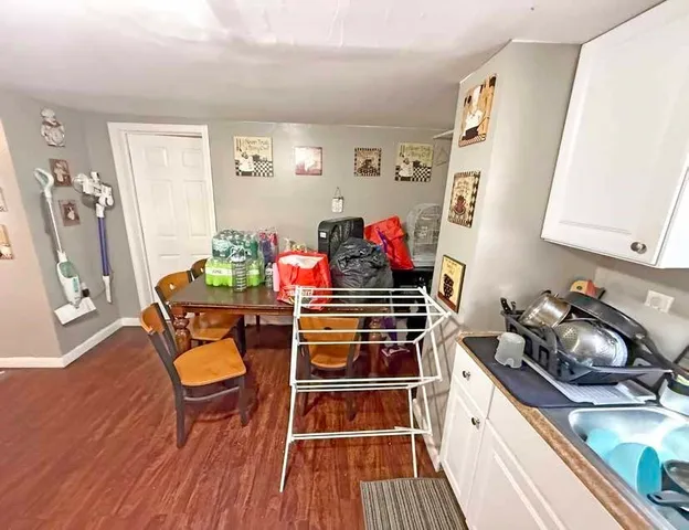 a room with wooden floor and cabinets