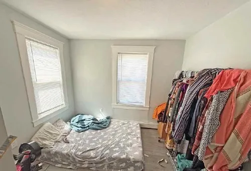a bedroom with a bed and a window