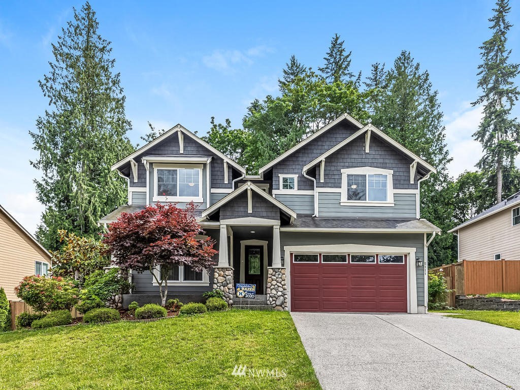 5111 Northeast 25th Street Renton, WA 98059 - Photo 1 of 29 a front view of a house with a garden and plants