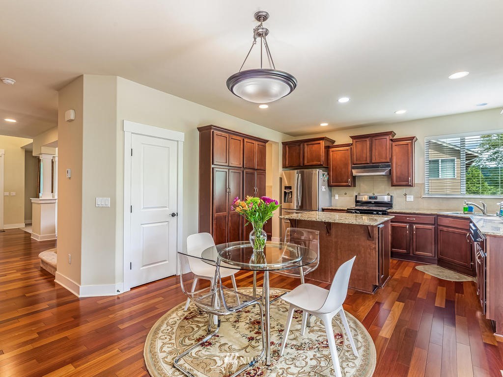 5111 Northeast 25th Street Renton, WA 98059 - Photo 14 of 29 a view of a dining room with furniture wooden floor and chandelier