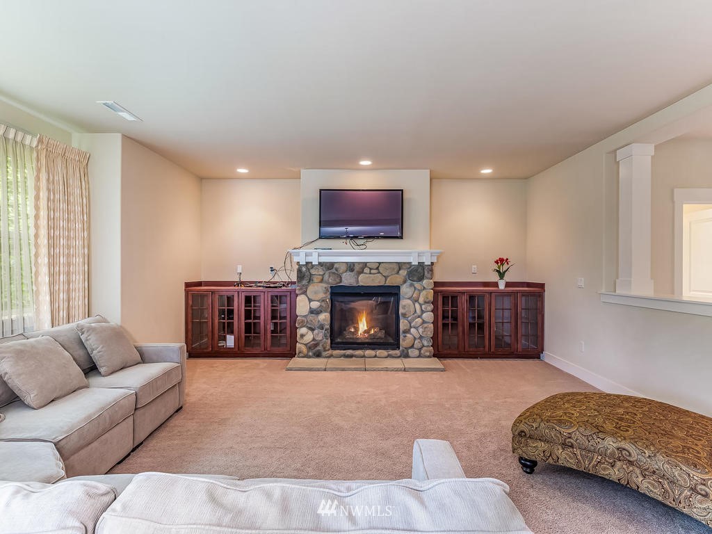 5111 Northeast 25th Street Renton, WA 98059 - Photo 15 of 29 a living room with furniture and a fireplace