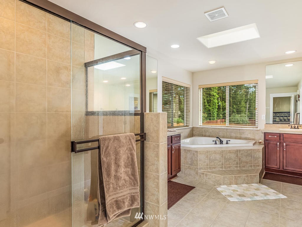 5111 Northeast 25th Street Renton, WA 98059 - Photo 19 of 29 a spacious bathroom with a tub shower and sink