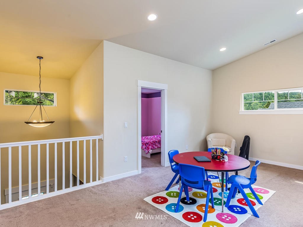 5111 Northeast 25th Street Renton, WA 98059 - Photo 21 of 29 a living room with furniture and a baby crib