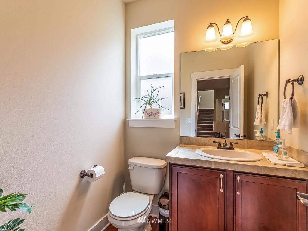 5111 Northeast 25th Street Renton, WA 98059 - Photo 23 of 29 a bathroom with a sink a toilet and a mirror
