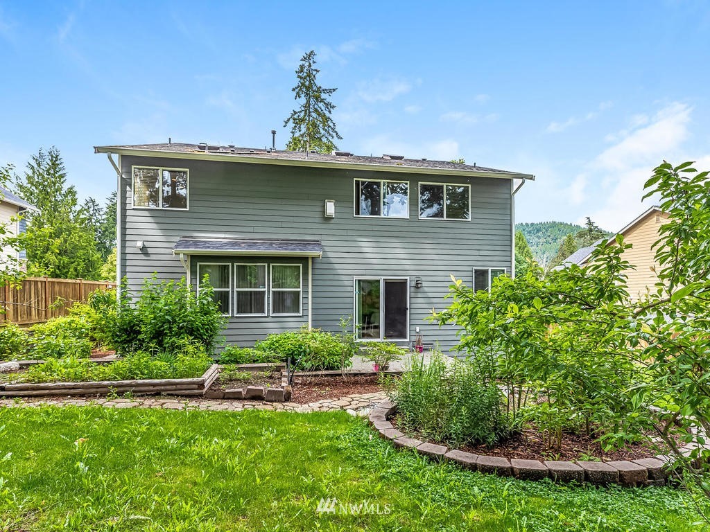 5111 Northeast 25th Street Renton, WA 98059 - Photo 25 of 29 a front view of a house with a yard and porch