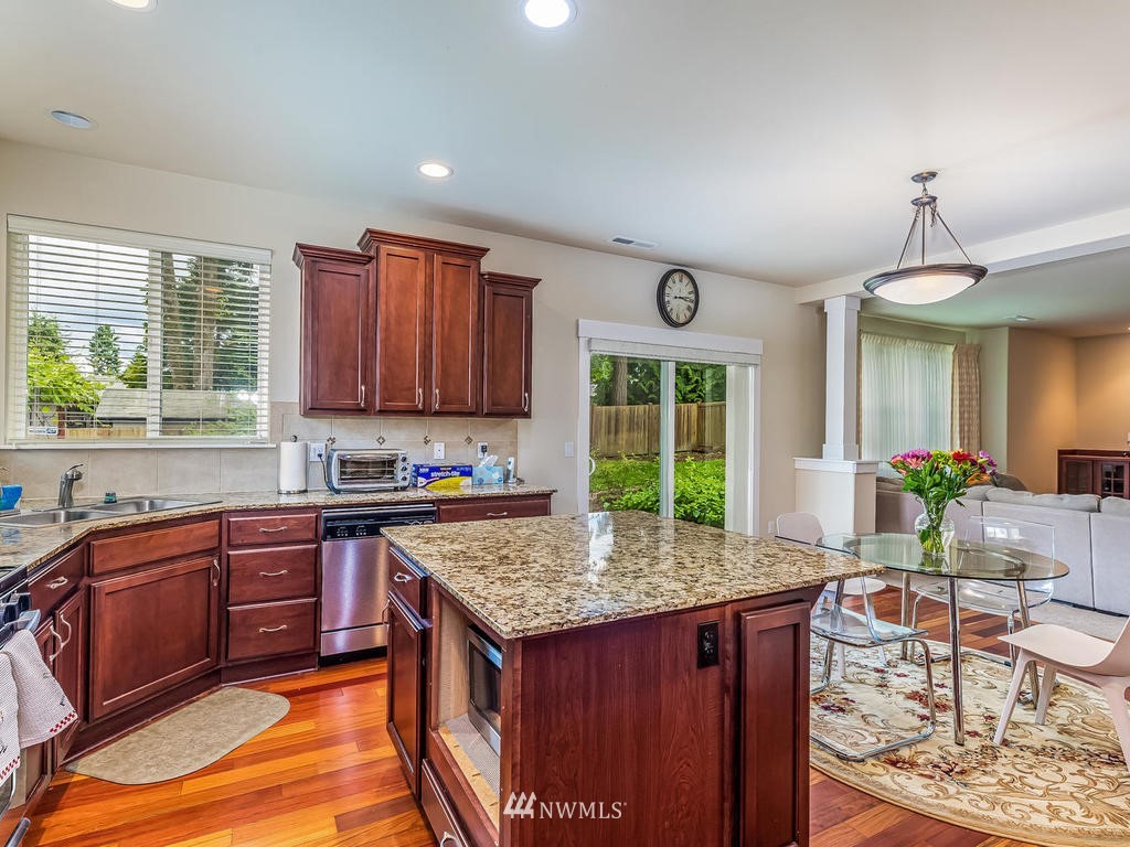 5111 Northeast 25th Street Renton, WA 98059 - Photo 10 of 29 a kitchen with granite countertop wooden cabinets and a granite counter tops
