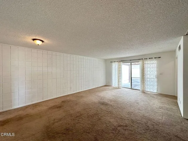 a view of an empty room with windows