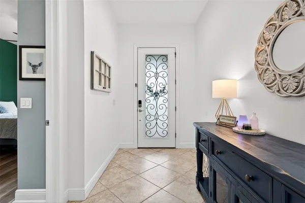 a living room with furniture kitchen view and a large window