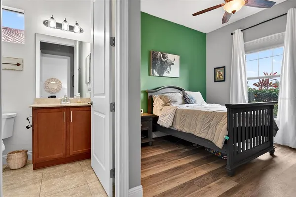 a living room with furniture kitchen view and a large window