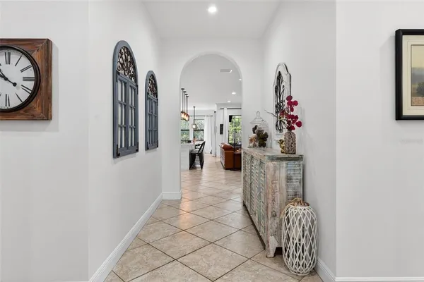 a kitchen with stainless steel appliances granite countertop a stove a sink dishwasher a dining table and chairs with wooden floor