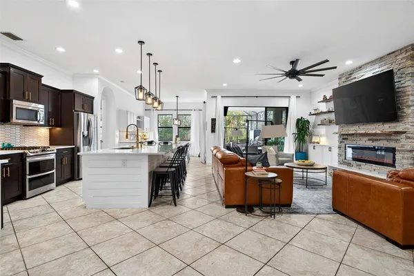 a dining room with furniture a chandelier and window