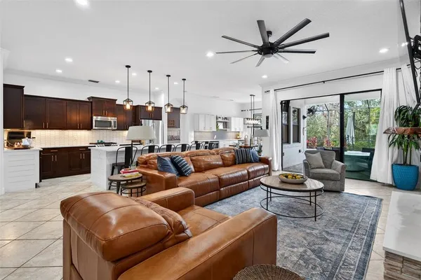 a kitchen with granite countertop a table chairs stove and refrigerator