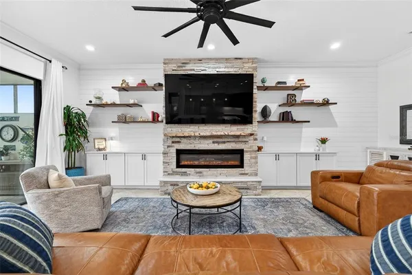 a kitchen with stainless steel appliances kitchen island granite countertop a table chairs sink and cabinets