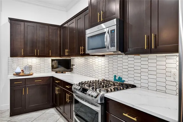 a utility room with stainless steel appliances granite countertop a washer and dryer