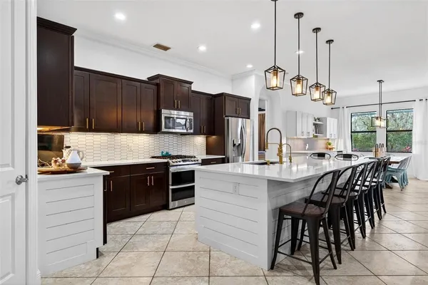 a living room with furniture and paintings on the wall