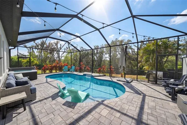 a view of a house swimming pool and a yard