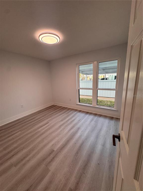 1 Windrush Boulevard, Unit 103 Indian Rocks Beach, FL 33785 - Photo 14 of 16 an empty room with windows